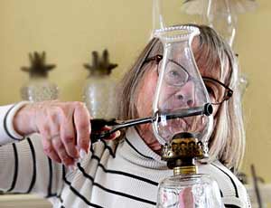 Through-Chimney Curling Iron Heater Photo showing curling iron inserted in thru-chimney heater